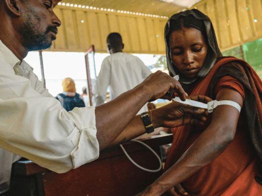 A Sudanese woman is screened for malnutrition in South Darfur.