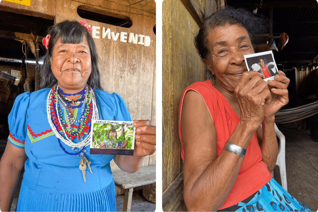 Women from local communities in Chocó hold photos of themselves.