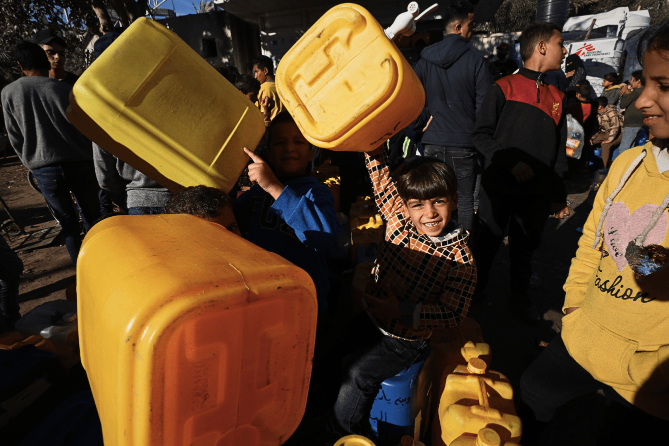 Palestinian children fetch water in Rafah, Gaza.