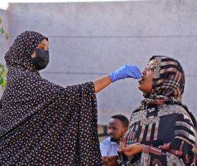 A woman administers a cholera oral vaccine in Ethiopia.